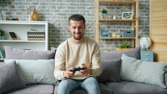 Man playing video games on a couch
